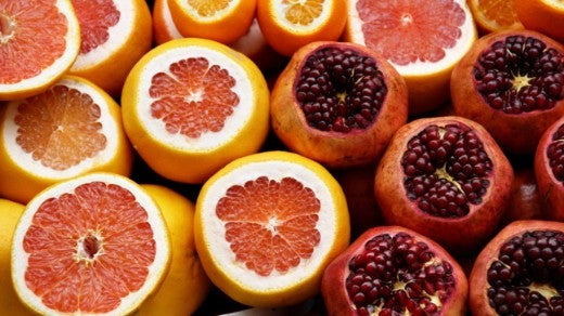 Cut pieces of citrus fruit and pomegranates