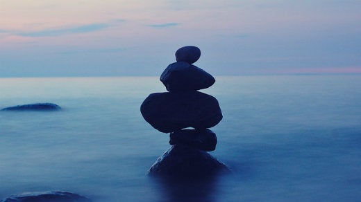 Stack of rocks in blue mist